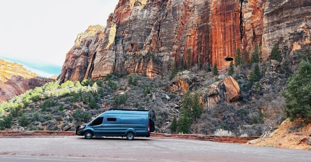A gray Ford Transit van at Zion National Park depicting adventures in van life and rv travel