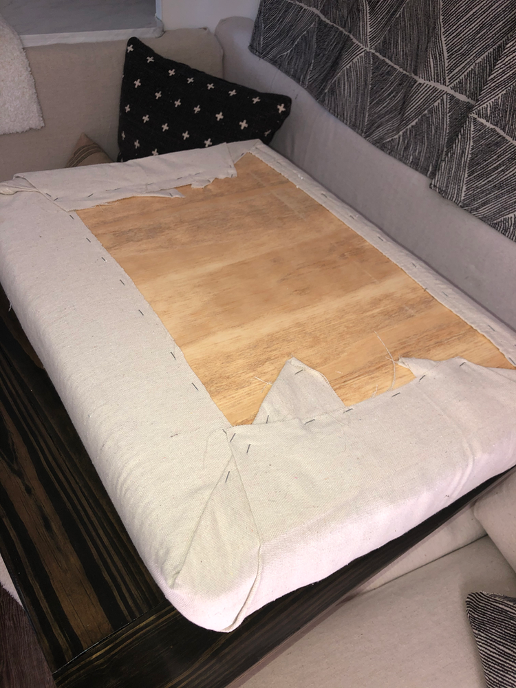 A dinette cushion being reupholstered with drop cloth