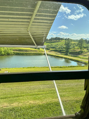 A view of a pond from a camper window