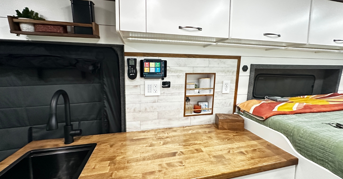 A view of a Ford Transit camper van galley and bed