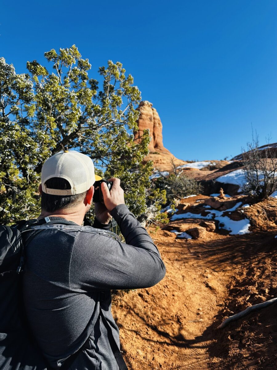 A man taking a photo in a snowy desert